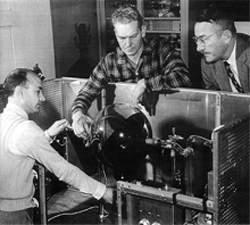 Photograph of Willard Bennett and colleagues working on Bennett's experimental tube called the Störmertron.