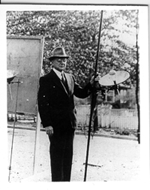 Photo of Charles McGee Heck with a meteorological instrument.