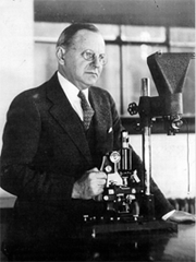 Photo of Heck with microscope.