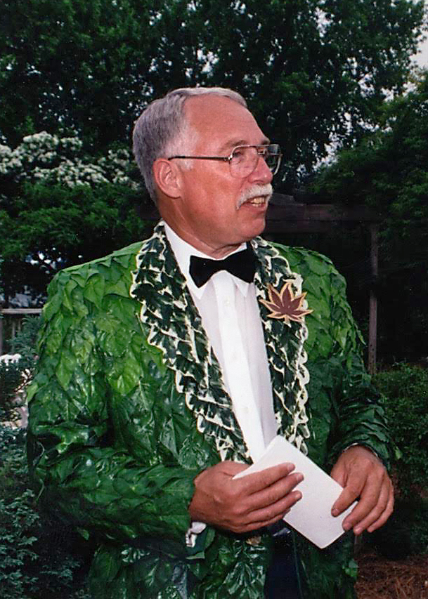 Man in a bright green suit jacket with a floral accent