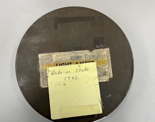 Metal can holding a film reel "Duke vs. State" from 1942