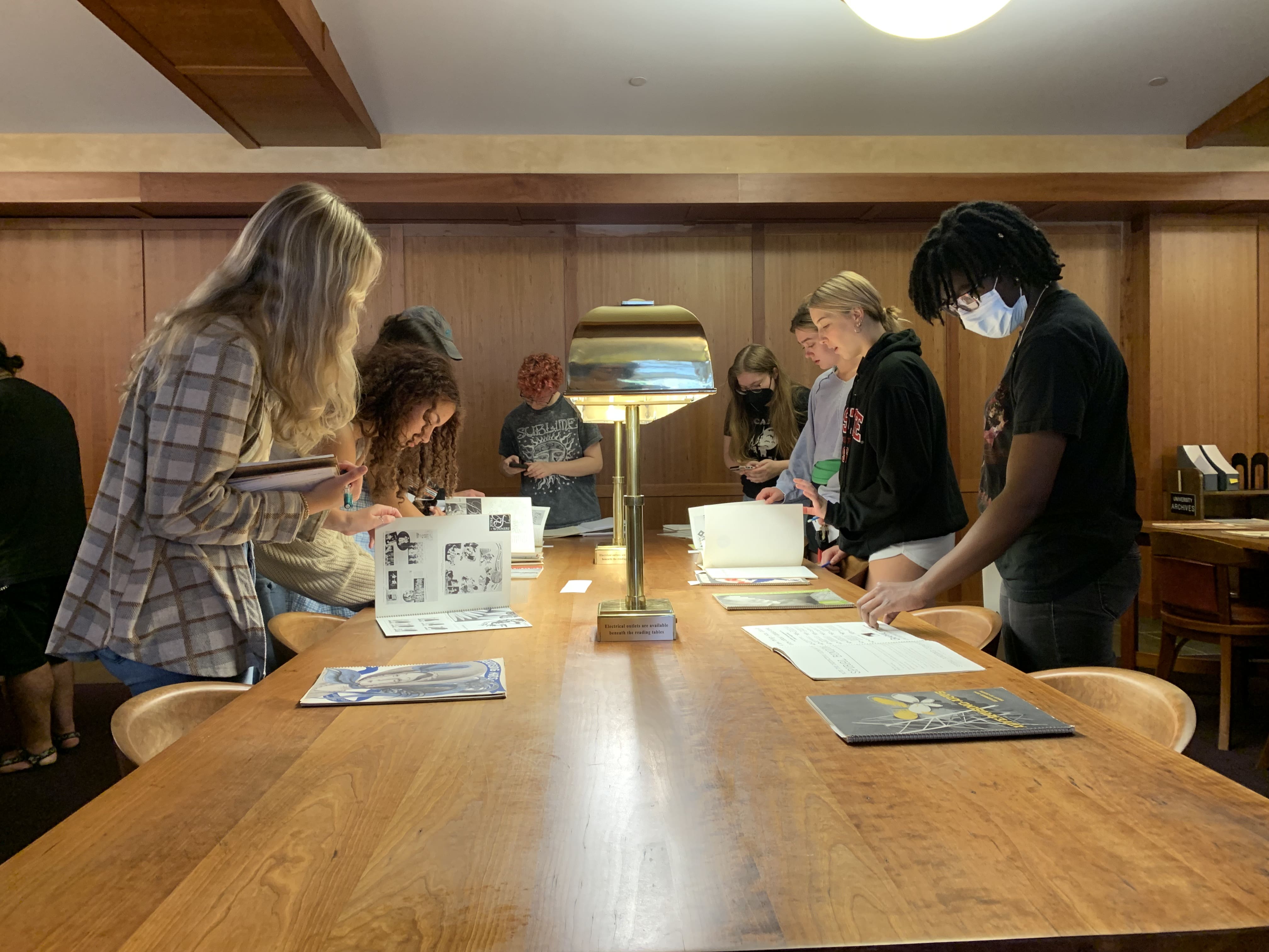 Undergraduate students exploring a collection in the D.H. Jr. Hill Library reading room. 