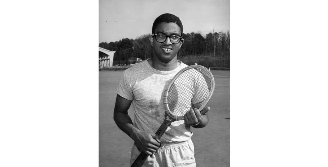 Irwin Holmes with tennis racket.