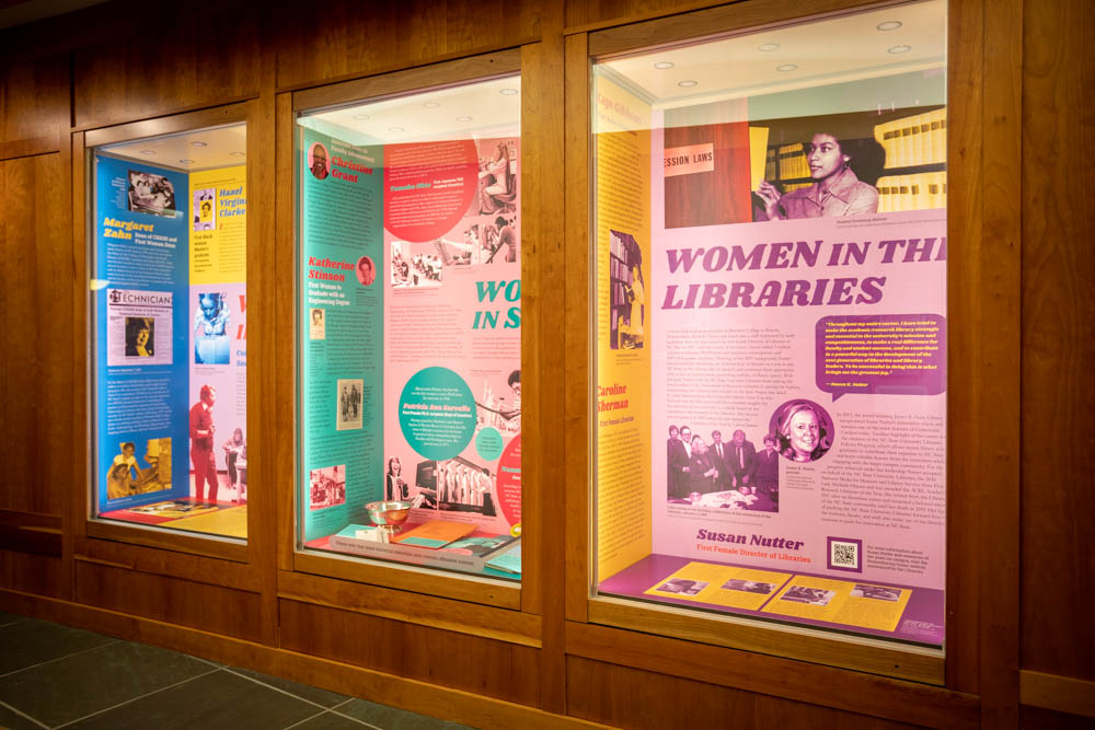 A set of cases in the exhibit features women in the Humanities, women in STEM, and women in the Libraries.