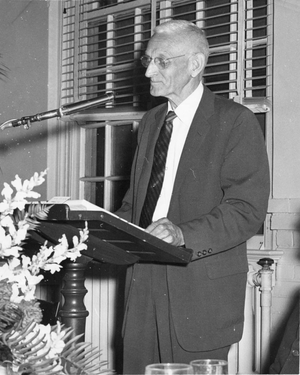     Edward S. King, general secretary of North Carolina State College YMCA from 1919 to 1955, standing at podium, 1960