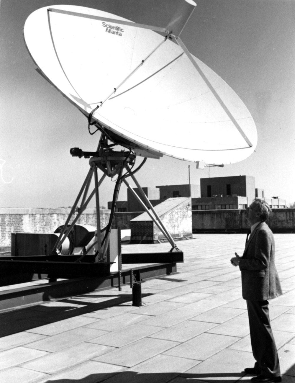Black and white photograph of a satellite dish atop Daniels Hall, now renamed 111 Lampe Drive.