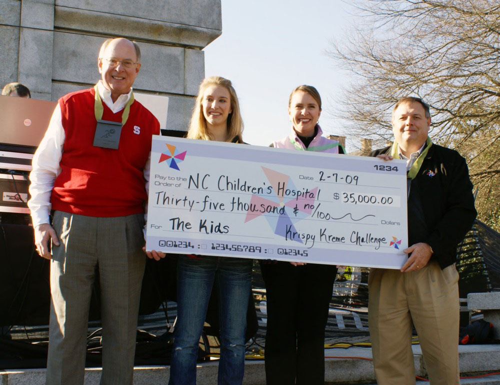 Chancellor Oblinger and others presenting an over-sized check for the NC Children's Hospital at the 2009 Krispy Kreme Challenge