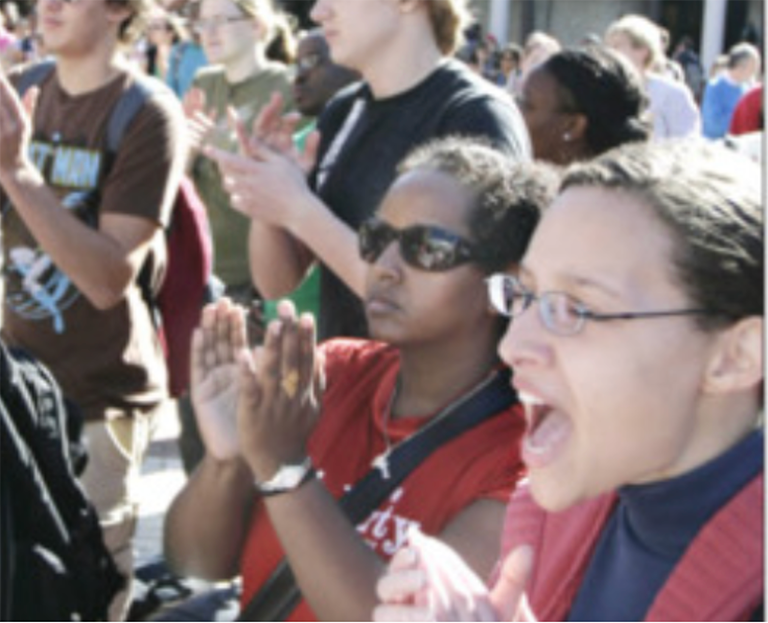 Two female students cheer during unity rally in 2008
