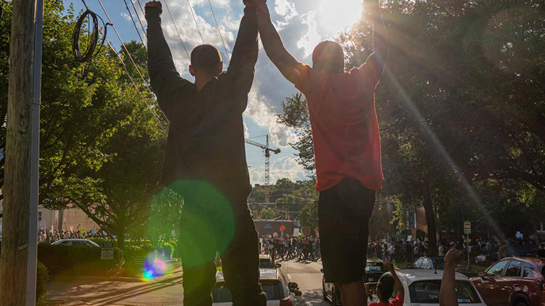 Protesters stand atop their car during the protest for the death of George Floyd on Saturday, May 30, 2020 in downtown Raleigh. The protest was one among many around the United States in response to the death of George Floyd in Minneapolis.