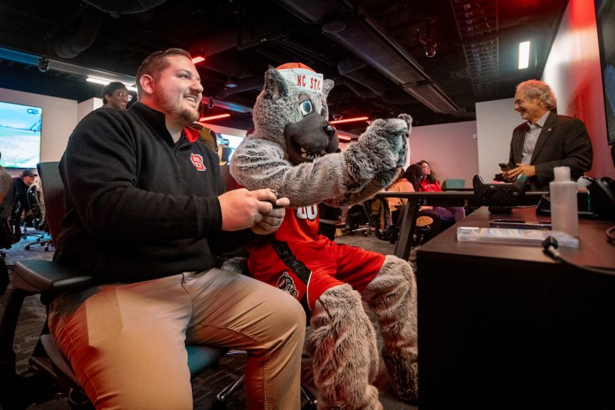 Director of NC State Esports Cody Elsen plays Mr. Wuf in the Gaming and Esports Lab at the Hunt Library.