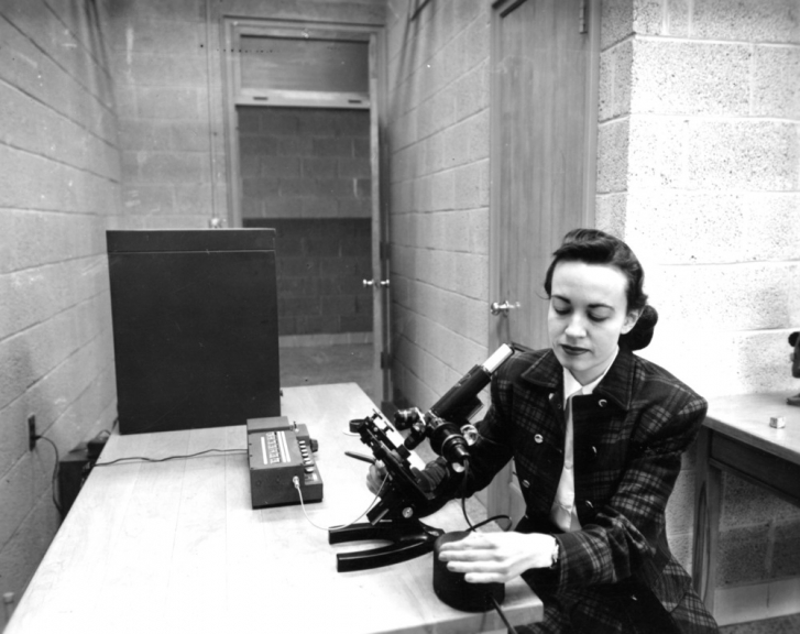 Frances M. Richardson with a microscope.