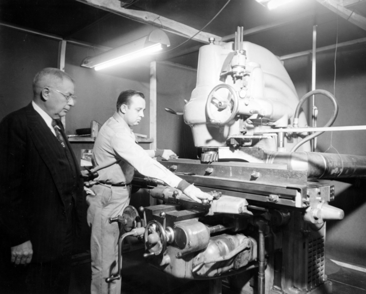 Fred Wheeler, left, supervises grinding graphite for the nuclear reactor, 1951