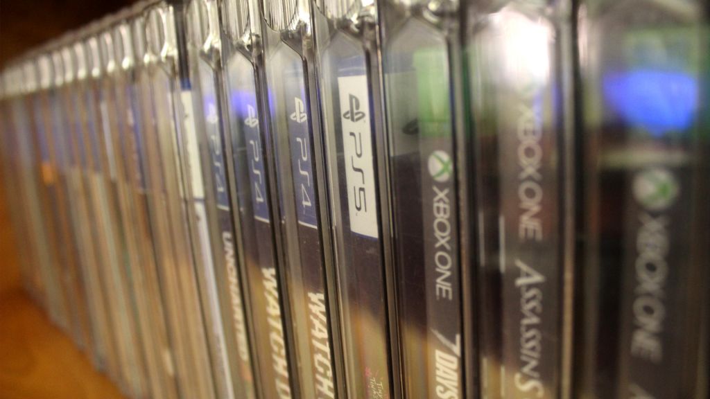 An assortment of video games cases on a shelf.