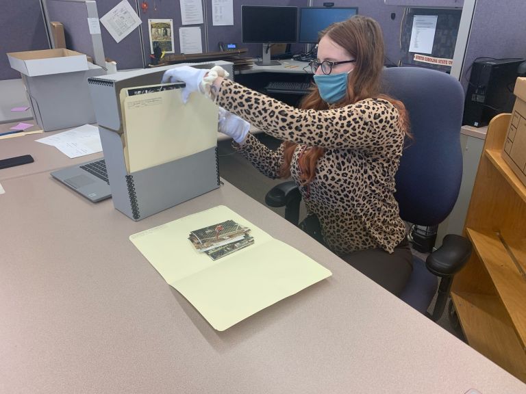 Taylor Wolford processing archival materials for the Special Collections Research Center