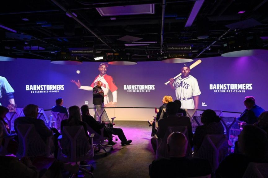 image of a large projection screen show two characters from baseball video game