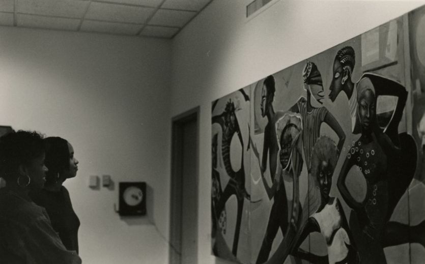 NC State's African American Cultural Center (AACC) celebrates 50 years in 2020.  Here, students view a Chandra Cox painting in the AACC gallery, 1994.