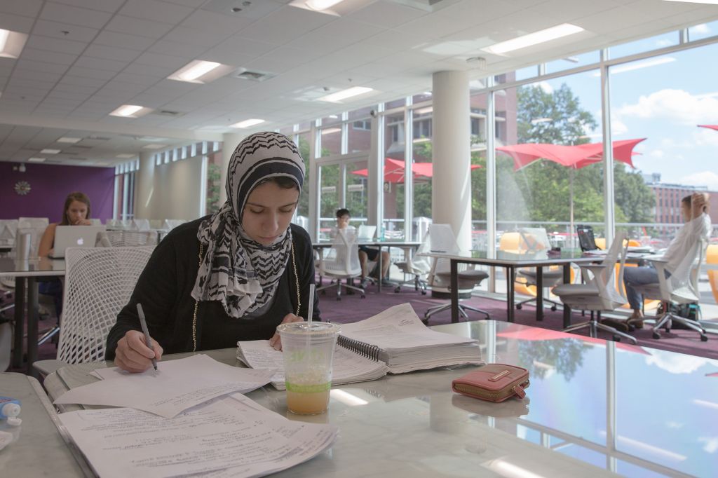 Student working at a table in Hill Library's silent reading room.