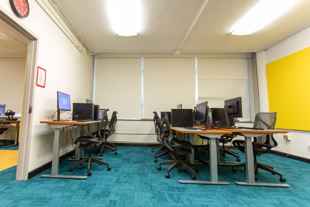The room appears to be set up for multiple users to engage in computer-based work, possibly including VR or other high-performance computing tasks.