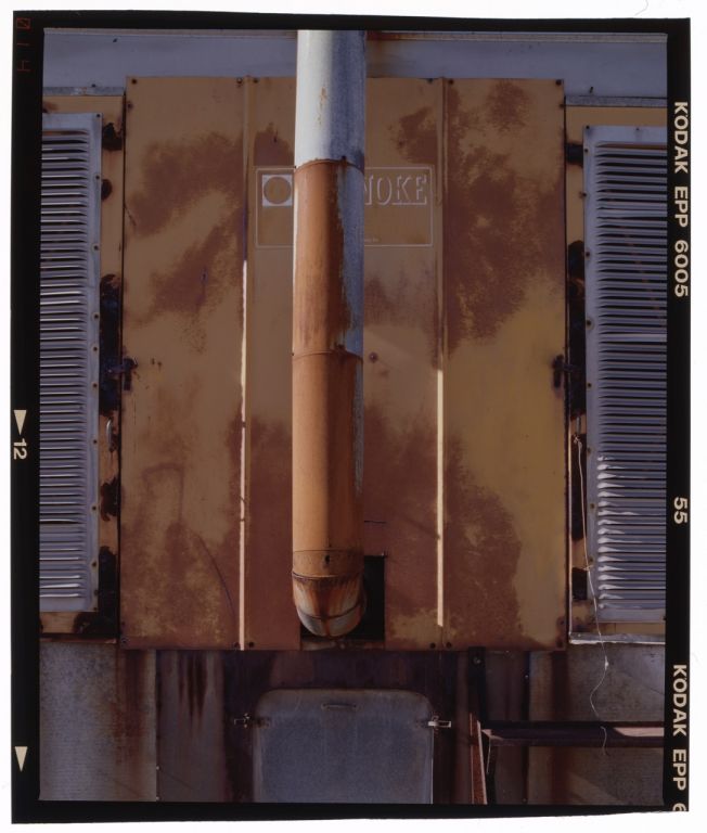 Photo of a rusted barn exhaust stack