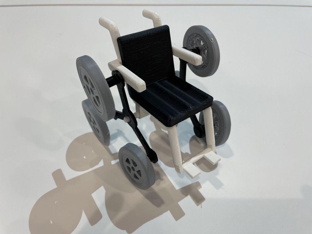Photo of a 3D printed wheelchair with three wheels