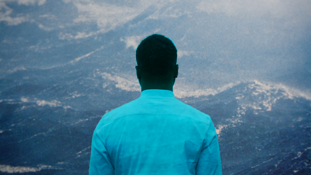 image of person in blue shirt with their back to the camera
