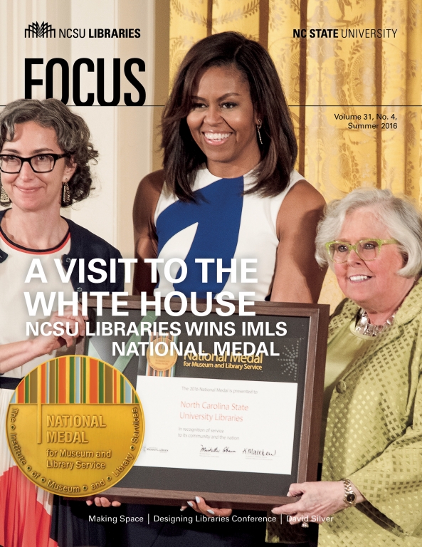 Susan K Nutter and Michelle Obama holding plaque.