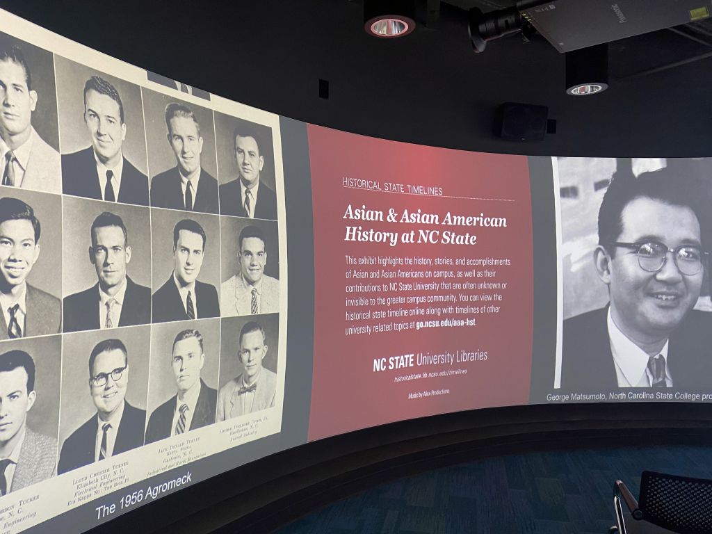 Wide screen showing yearbook photos of eight white men and one Asian man