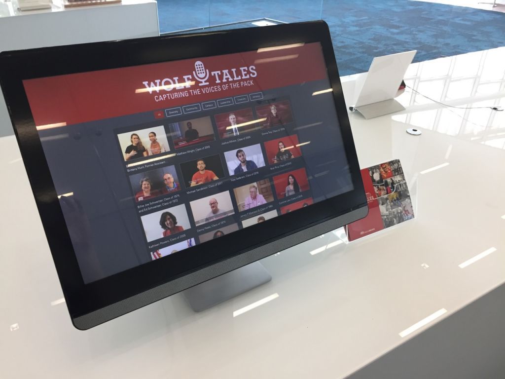 Computer monitor displaying a grid of faces of Wolf Tales interviewees
