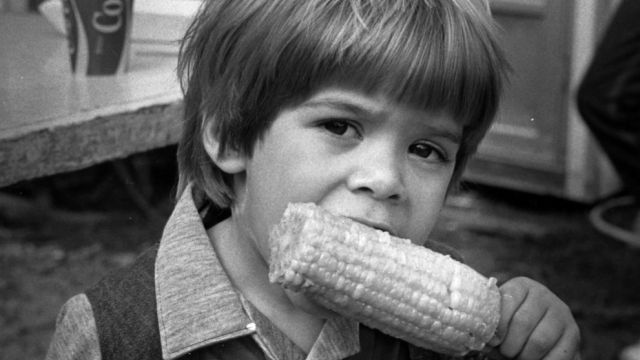Boy eating corn on the cob at the NC State Fair, ca. 1979