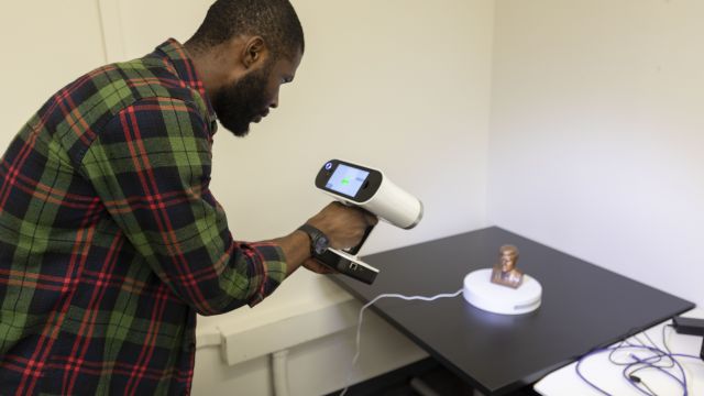 Man using the Artec L E O to scan an object.