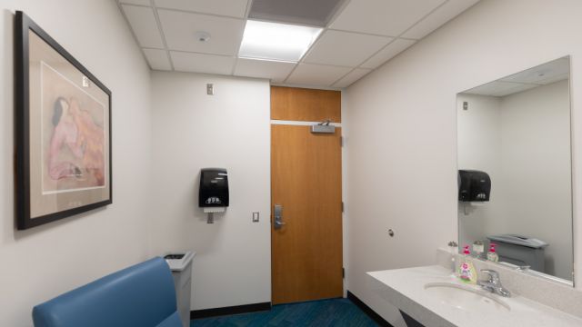 Hill Library Lactation room with countertop, sink, paper towels, and chair.