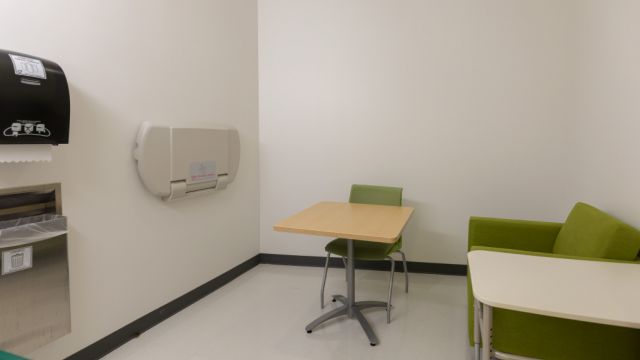 Hunt Library Lactation room with changing table, table, chair, and soft seating.