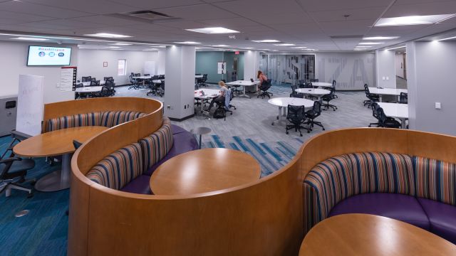 A large space with booth seating, and also ten big tables and office chairs