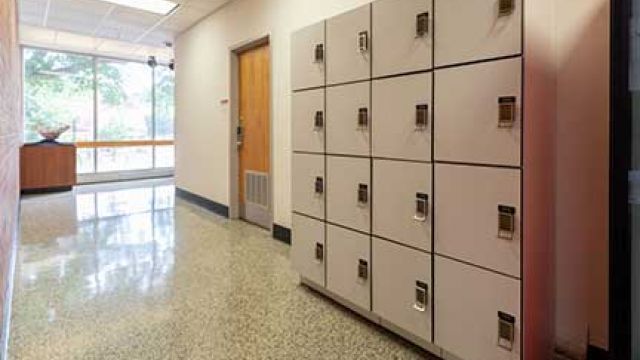 Cube of sixteen lockers with keypad combination closure behind the Ask Us desk