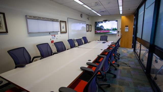 View of conference room A103 in the Veterinary Medicine Library. Shows view of door and monitor near entrance.