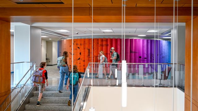 Colorful exterior of the Gallery, with students walking up stairs in front of it