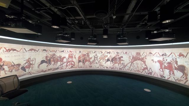 projection of Bayuex tapestry with embroidered horses and soldiers