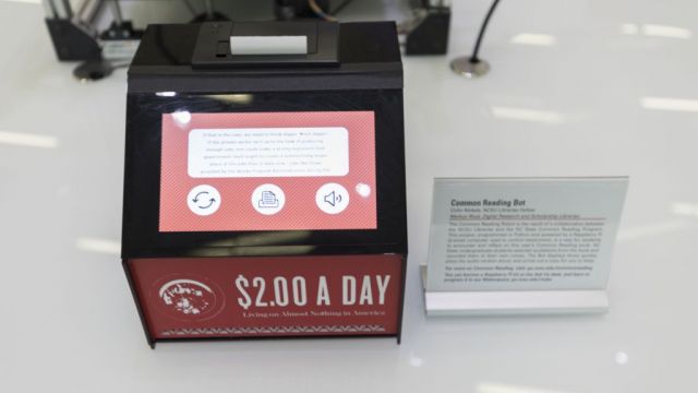 Small device with a screen displaying text and a label that says $2 a day