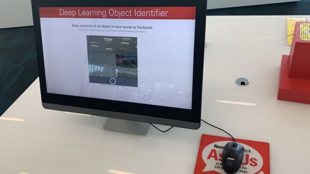 A computer monitor reads, Deep Learning Object Identifier. Snap a picture of an object in your purse or backpack. The screen shows a view of the webcam