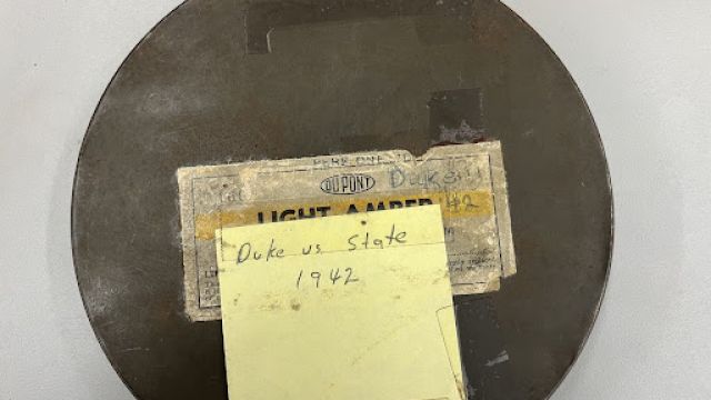Metal can holding a film reel "Duke vs. State" from 1942