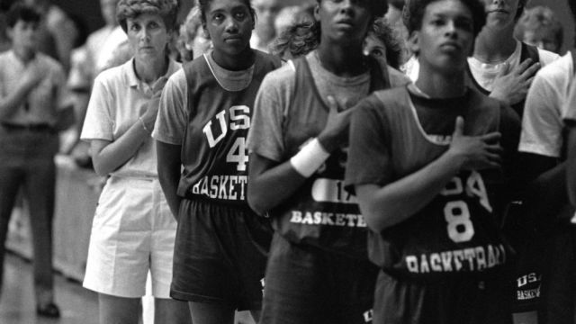 Coach Kay Yow and the United States Olympic team show pride during the playing of the National Anthem before an exhibition game in Raleigh (1988).