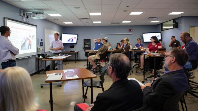 In a photo from the blogpost Mike Cuales (front left) and David Woodbury (front right) give a presentation at San Diego State University about immersive learning technologies and spaces. Photo courtesy of San Diego State University.