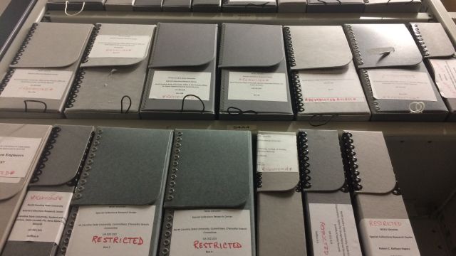 Shelves of restricted boxes from University Archives