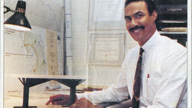 Architect and NC State College of Design alumnus Phil Freelon, sitting at his desk when he was working at O'Brien Atkins Associates.