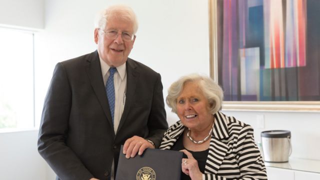  U.S. Representative David Price presents Vice Provost & Director of Libraries Susan Nutter with a signed copy of the June 10, 2016 Congressional Record.