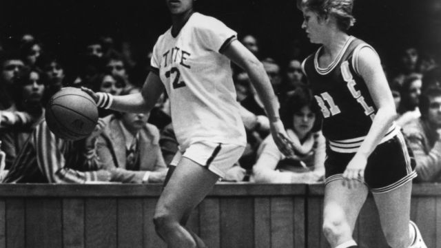 N.C. State's #12 Trudi Lacey dribbles down the court with UCLA opponent on defense, 1977 to 1978.