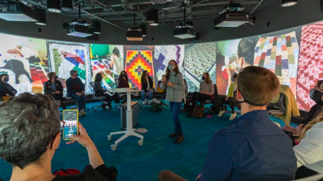 A panorama of quilts displayed on the Visualization Studio walls