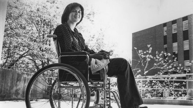 From the University Archives Photograph Collection, an image of a student in wheelchair on campus, taken circa 1977 to 1981.