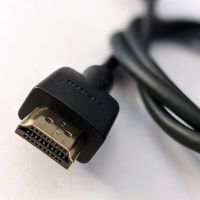 Close-up of an HDMI cable, which has an end shaped like a ravioli seen from the side