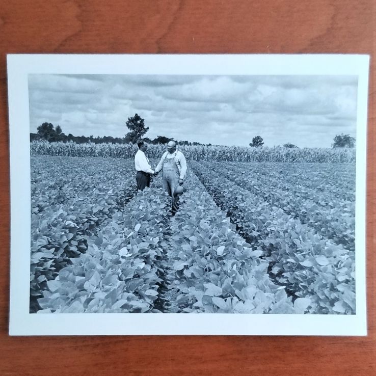 An unidentified extension agent or faculty/staff member and an unidentified soybean farmer (Box 57, Folder 9)